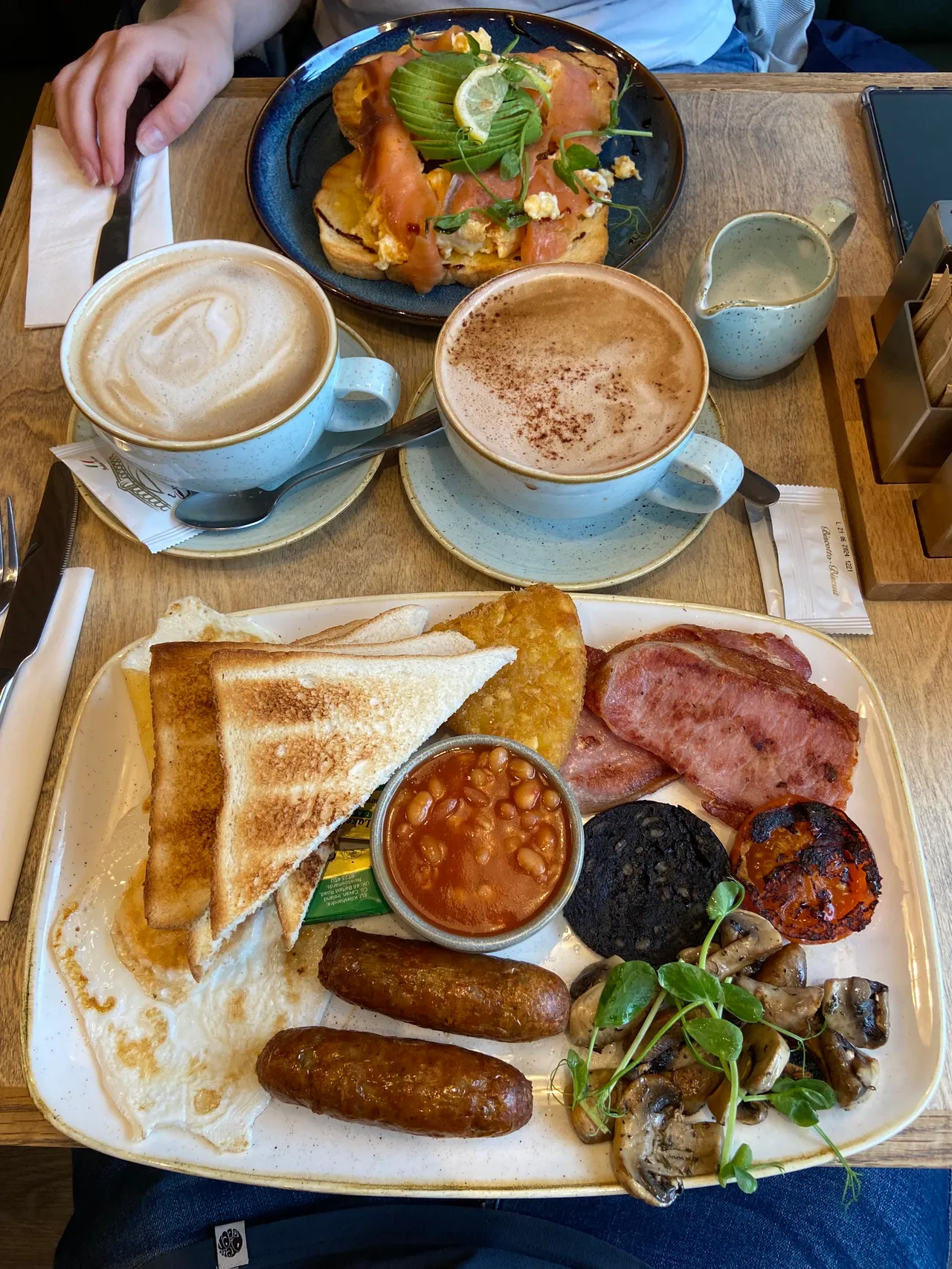 Breakfast plates and coffees shared at a café table