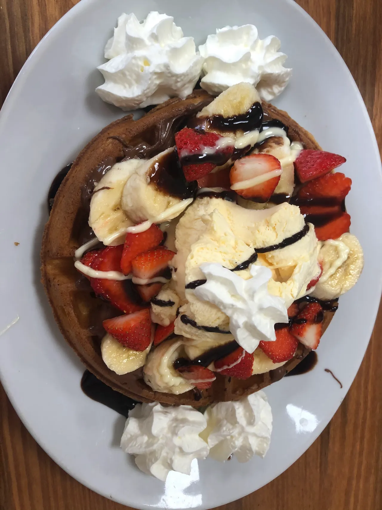 A waffle with fruit and ice cream at Corner House